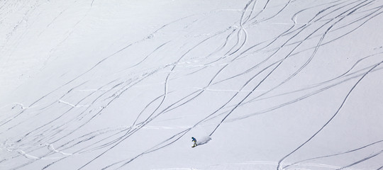 Panoramic view on snowboarder downhill on off piste slope with n