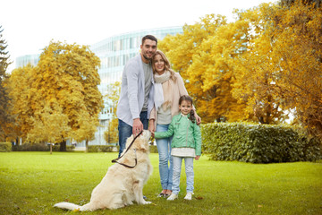 happy family with labrador retriever dog in park