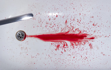 A drop of blood in the bath and faucet
