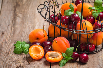  Apricots and cherries on rustic  background