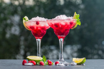 margarita cocktail with lime and raspberries