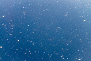 Ocean waves as seen from airplane window. Sea background