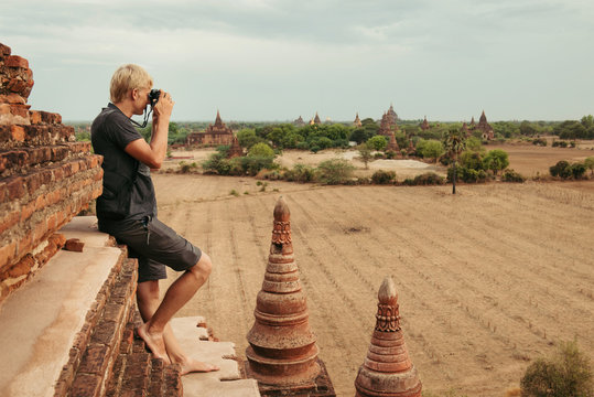 Tourist taking photos of sunrise on the top of pagoda in Myanmar, Bagan