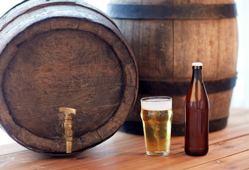 close up of old beer barrel, glass and bottle