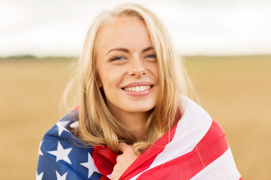 happy woman in american flag on cereal field