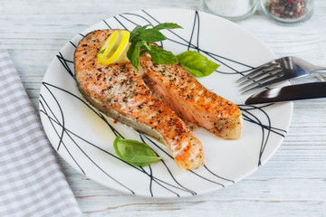 Grilled Salmon steak with lemon and herbs.