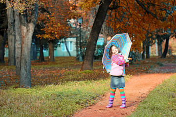 happy little girl in park autumn season