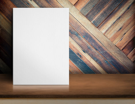Blank White paper poster on wooden table at diagonal wood plank