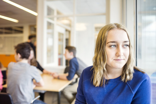 Portrait of schoolgirl (12-13) looking through window