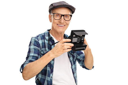 Elderly hipster holding a polaroid camera