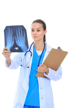 Young female doctor looking at the x-ray picture isolated on white background