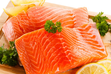 Fresh raw salmon steaks on cutting board 