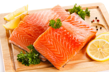 Fresh raw salmon steaks on cutting board 