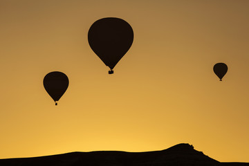Silhouette of balloons over sunrise in Cappadocia, Turkye