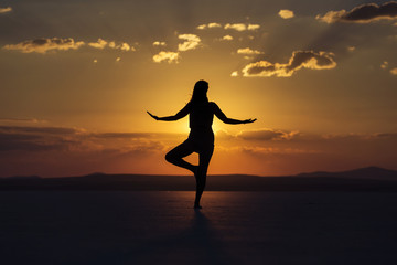 Woman on yoga posture on sunset