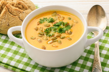 Vegetarian meal - cream carrot soup with pumpkin seeds. 
