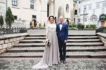 Beautiful luxury newlyweds near the church