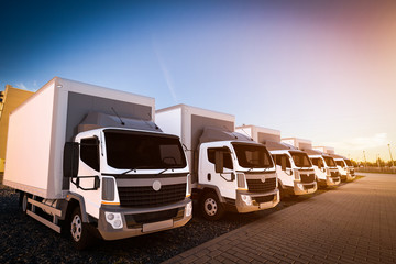 Fleet of commercial delivery trucks on cargo parking