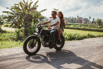 Obraz na płótnie Canvas Young couple riding motorbike