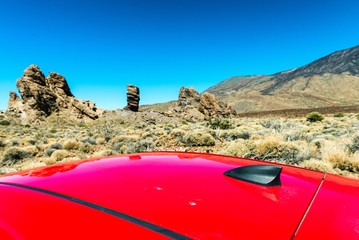 Fototapeta na wymiar Red car roof with mountain scenario