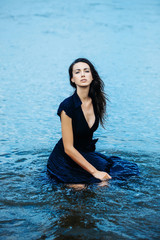 Fototapeta premium young sexy woman sitting in water