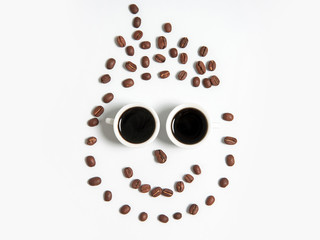 smiley of coffee beans in cups isolated on white
