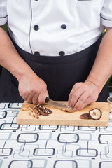 Chef is cutting mushroom