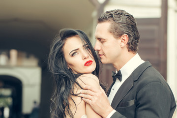 Handsome groom holds beautiful bride