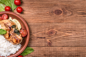 Spinach and cheese stuffed chicken breast  with rice. Background.