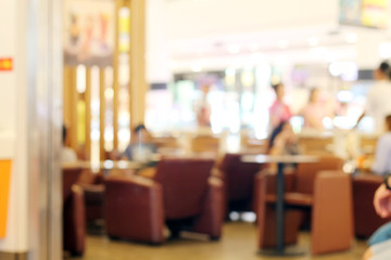 Blurry people drinking coffee at cafe