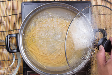 Closed up spaghetti boiling in the pan
