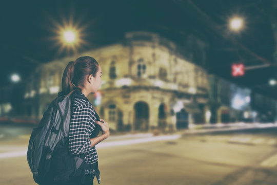 Traveling asian woman with backpack on dark night ,vintage style