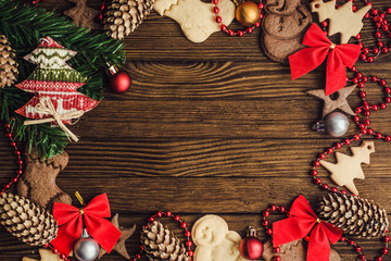 Christmas wooden background with Christmas cookies, cinnamon and Christmas tree.