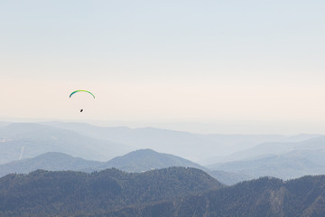 Paraglider flying over mountains