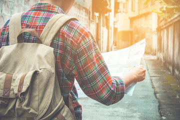 young tourist with a beard holding a map  choose where to travel