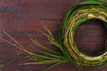 Wreath of green herbs on a wooden table