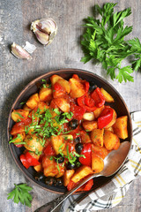 Mediterranean potato ragout with bell pepper and olives.Top view