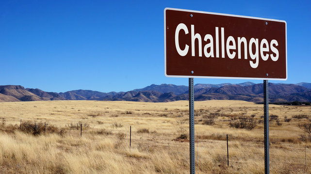 Challenges brown road sign