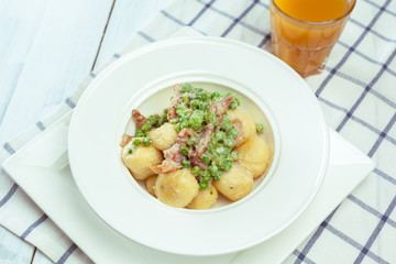 Potato dumplings with fried onion and bacon