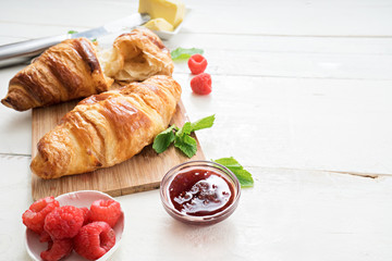 breakfast time with croissants and coffee on wooden table