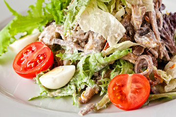 Salad with chicken, mozzarella and cherry tomatoes.