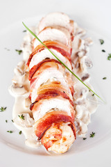 Stuffed turkey rolls with ham and spring onions in creamy sauce