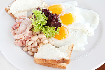 fried egg, vegetable salad and a grilled sandwich on a light bac