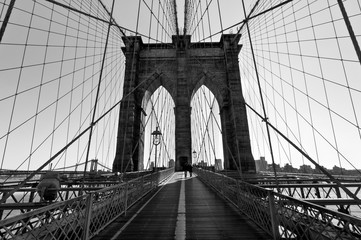 Walk across Brooklyn Bridge backlit - Black and White
