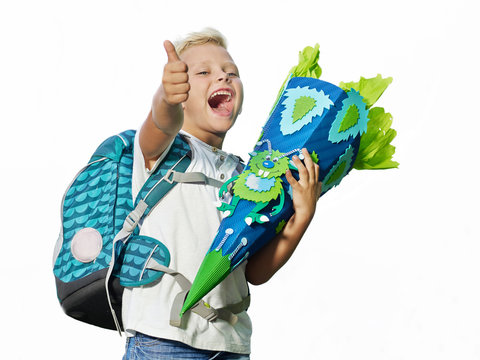 Cute child with school cone showing thumb up