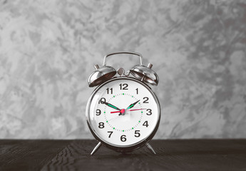 alarm clock on blask wooden table