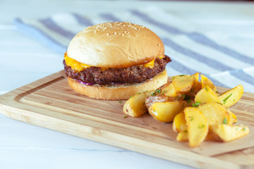 burger and french fries on wooden table