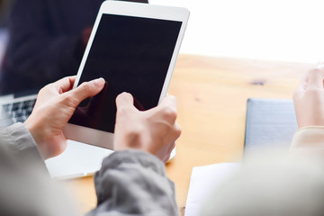 Woman typing text message on smart phone in a cafe. Cropped imag