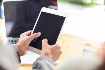 Woman typing text message on smart phone in a cafe. Cropped imag
