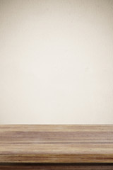 Empty wooden table over brown cement wall  background